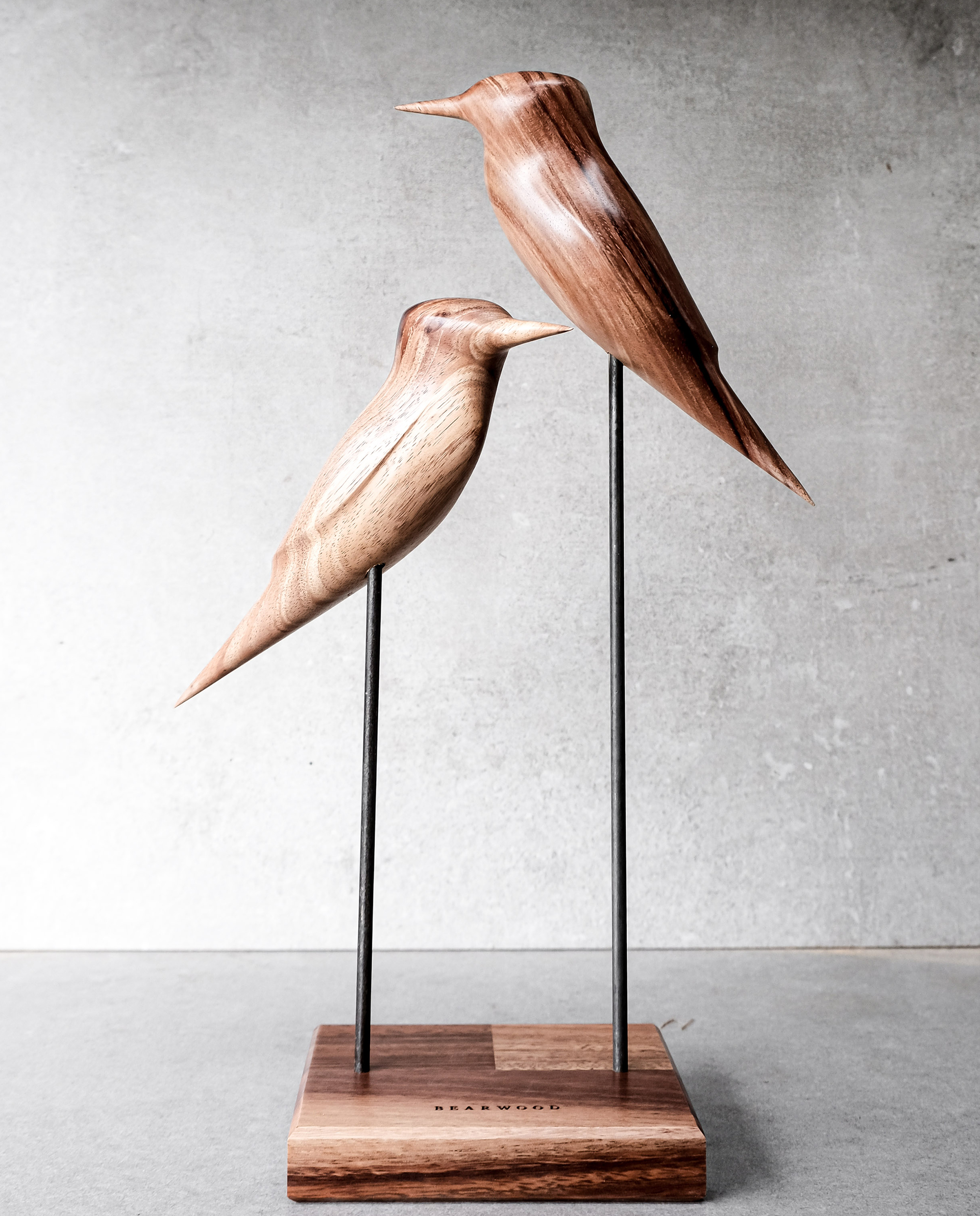 Minimalist Tasmanian blackwood kingfisher sculptures on steel rods with wooden base.