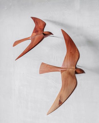 wooden falcon sculpture in flight, wall-mounted carving made from totara timber.