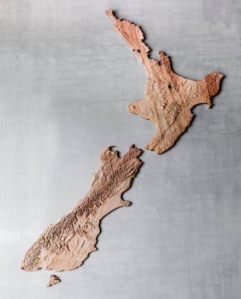 Carved wooden relief map of New Zealand wall art made from recycled kauri timber.